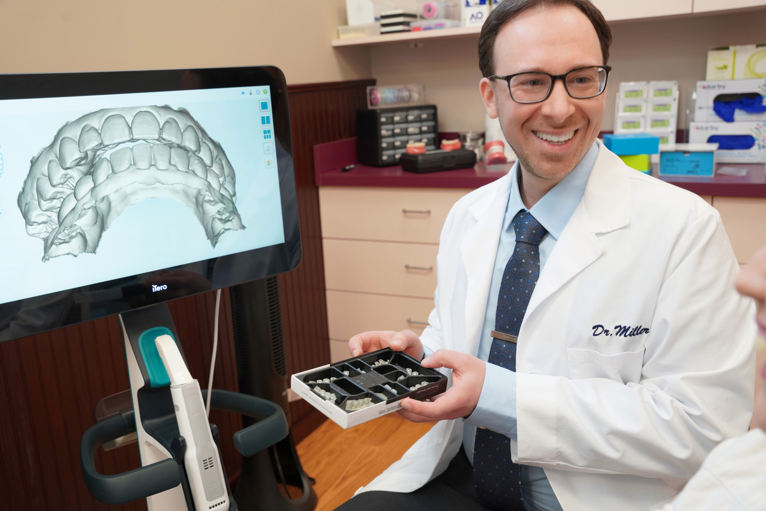Dr. Matthew Miller showing a patient their 3D scan at his Rocky Point office